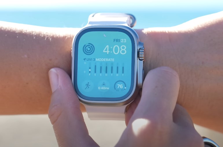 A modern smartwatch displays the time, date, and UV index